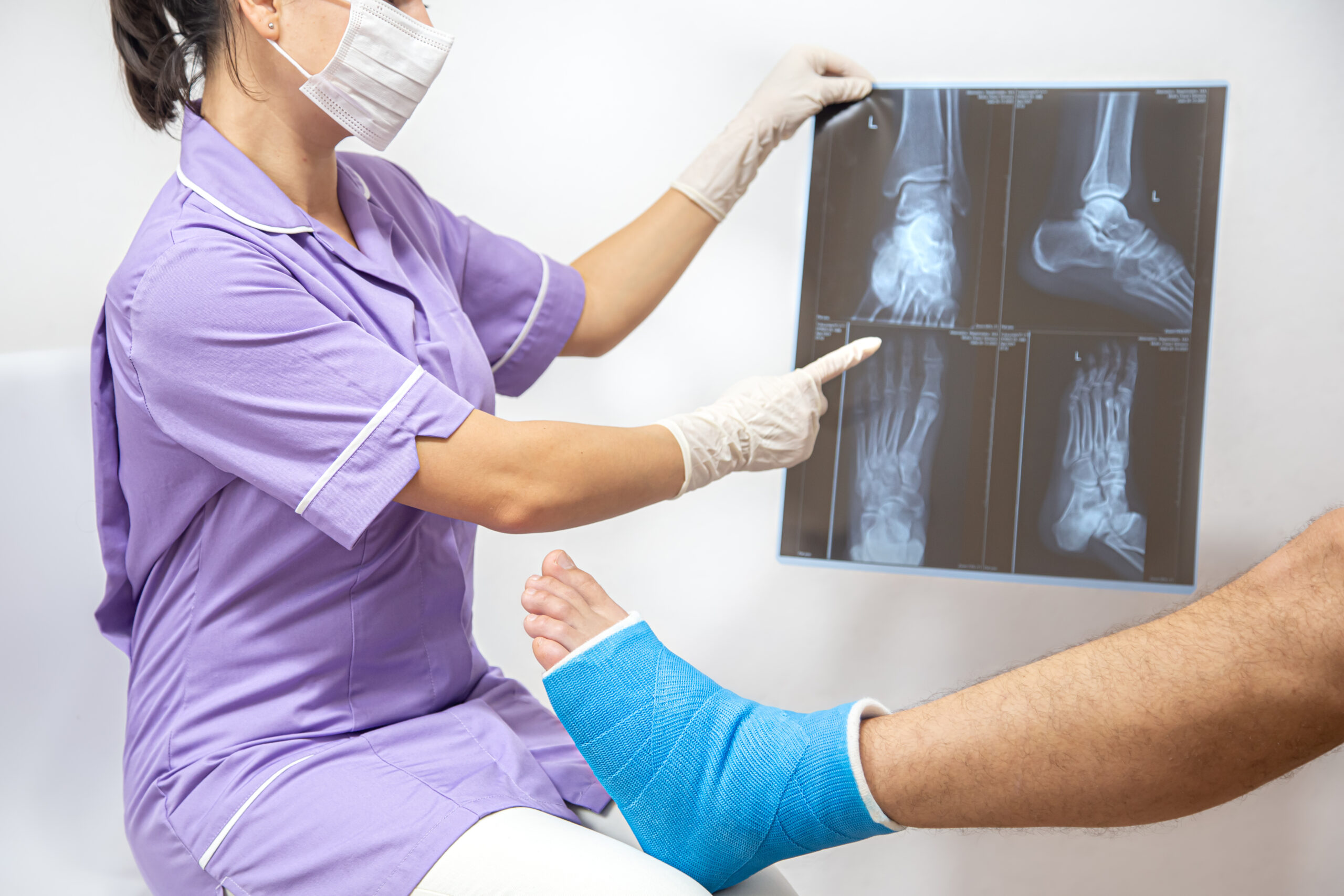 bone-fracture-foot-leg-male-patient-being-examined-by-woman-doctor-hospital